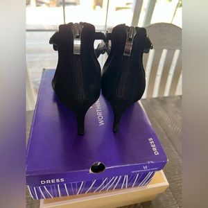 Black opened toe heels.